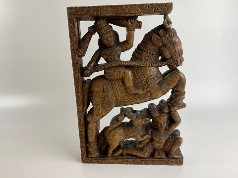 Handmade carving / panel of wood from Indian temple wagon to celebrate Hindu 
gods. Man on horse and man with dog