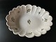 Antique, European, tin-glazed faience bowl with 
wavy edge and floral motif.