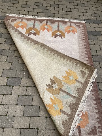 Vintage kelim rug with stylized tulips, presumably Swedish, in burnt colors, 
orange, brown, yellow, green