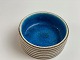 Italian ceramic bowl by Guido Gambone. Clear blue 
inside. Beige with brown stripes on the outside. 
Italy in the middle of the 20th century