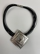 Large pendant in sterling silver / brooch in 
14-row leather necklace with clasp made of metal 
(presumably steel)