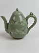 Small Chinese teapot with green cracked celadon 
glaze with cranes and clouds.