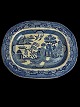 Antique faience serving dish with Chinese pattern. The pattern is called Blue 
Willow. Presumably English, Staffordshire. Indistinctly marked.